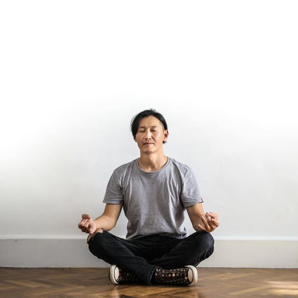 Man meditating in a calm environment, focusing on inner balance.